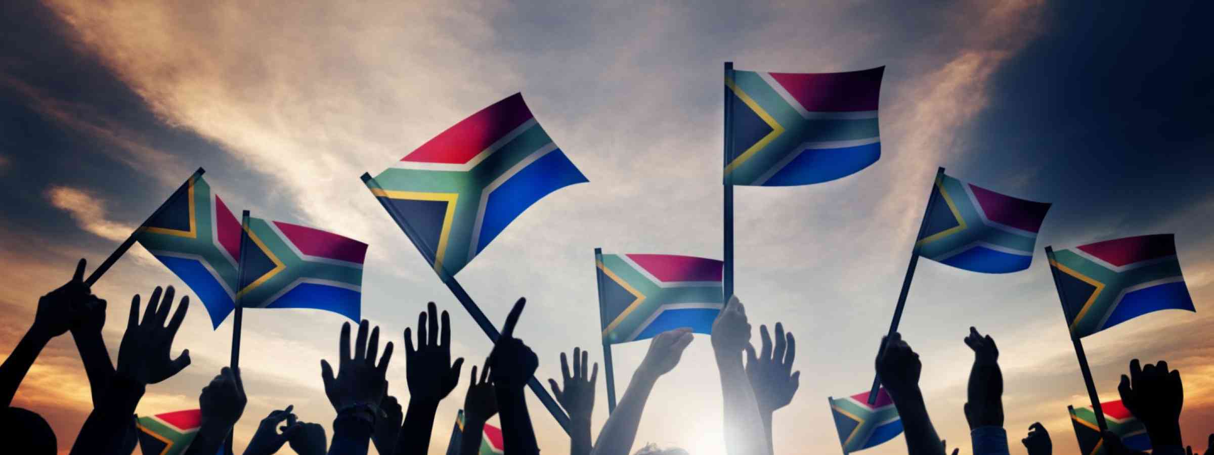 Group of People Waving South African Flags